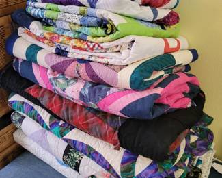 Assortment of beautiful, handmade quilts including a Double Wedding Ring and a Flying Geese.