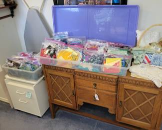 Batik scrap and remnant bags, antique buffet, small IKEA filing cabinet, ironing board.