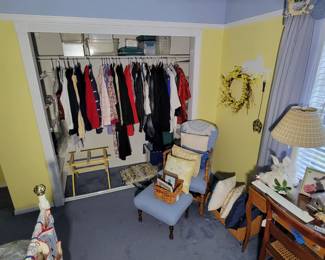 Assortment of nice coats and jackets, small custom upholstered chair and ottoman. Luggage rack, custom throw pillows.