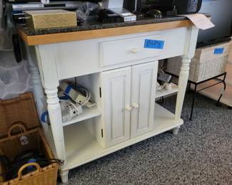 Marble topped cabinet. Used as a kitchen island.