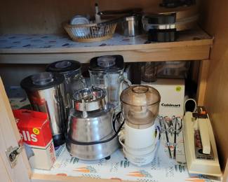 Small kitchen appliances, Oster blender, Cuisinart food processor, vintage hand mixer, waffle iron.