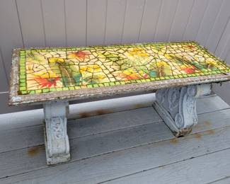Cement mosaic topped outdoor bench.