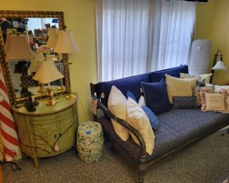Large wood daybed. Originally from World Market. Custom cushions and pillows. Pier 1 painted cabinet. Assortment lamps, yellow and blue ceramic drum table. Large gold mirror.