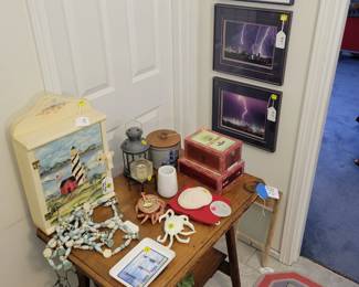 Antique table, misc beachy decor, lighthouse cabinet, Seattle lightening pictures. Lighthouse wool rug.