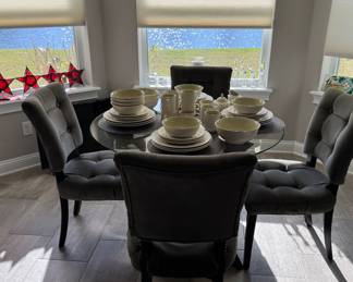 A nice glass top dinette set - a table and 5 chsirs