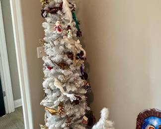 Skinny white flock tree, white feather tree, and many ornaments