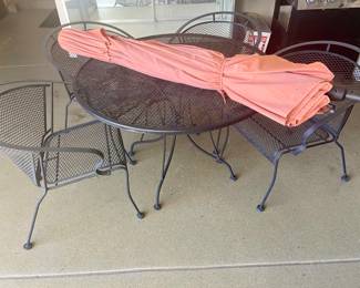 wrought iron patio table with 4 chairs; and umbrella