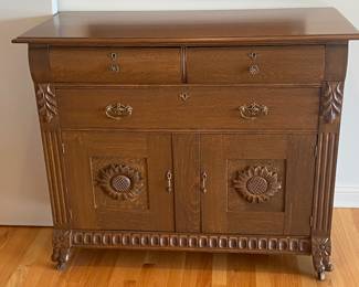 Sunflower motif carved wood chest on casters  
