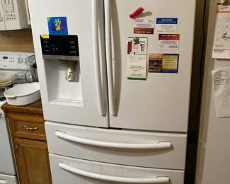 This is a two door refrigerator in the kitchen.