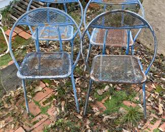 Four  matching metal chairs for the patio outside.