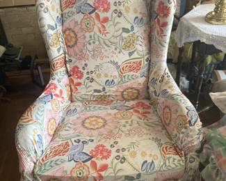This upholstered wing back chair is in the living room.