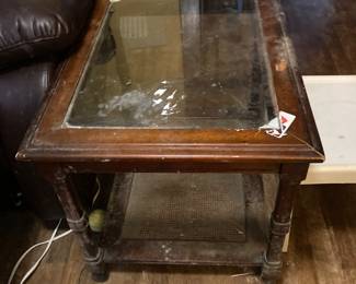 This is a nice glass top wooden table that needs a little TLC.