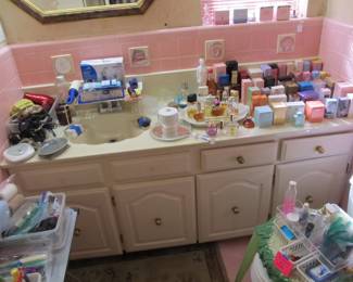 1956 pink bathroom with lots of wonderful toiletries and perfumes 