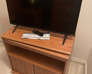 Swivel top media cabinet with lower storage and shown with Visio TV