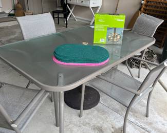 Patio table with glass top and 4 armchairs