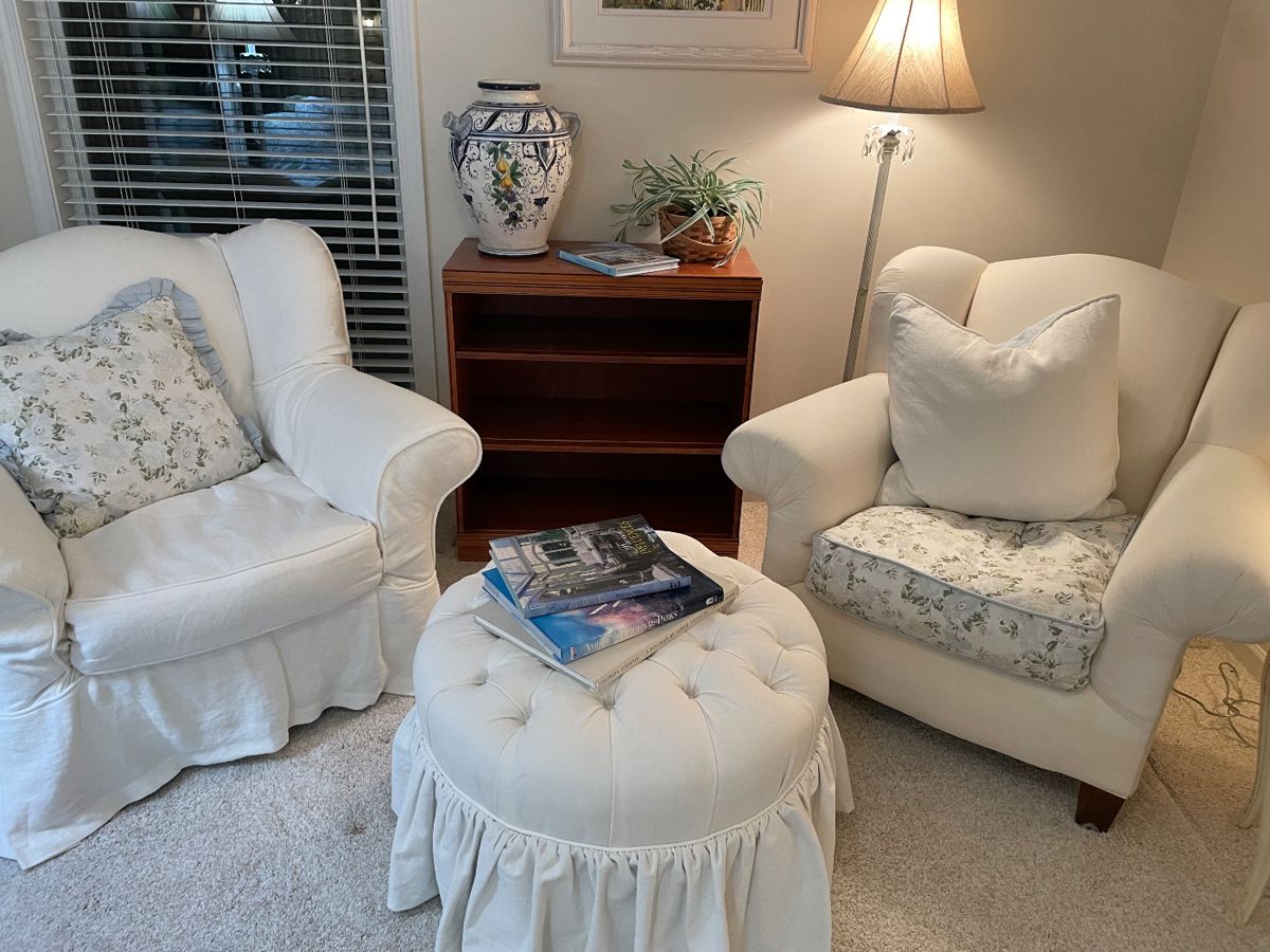Crate & Barrel slip-covered armchairs - white linen, and Ethan Allen tufted ottoman, bookcase, Italian pottery, and floor lamp