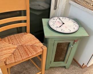 Counter-height rush seated chair, tin-front storage cabinet, and wall clock