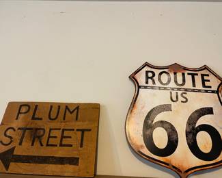Metal "Route 66" sign, and wood "plum street" signs