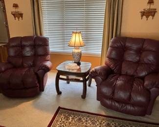 Maroon recliners, end table, lamp