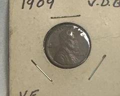 1909 V.D.B. Lincoln Wheat Cent. Key details about this coin: Year and Designer: Struck in 1909, it was designed by Victor David Brenner (V.D.B.). His initials appear on the reverse at bottom.