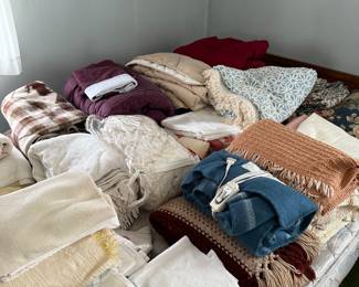 Blankets, sheets and comforters including vintage chenille bedspreads. 