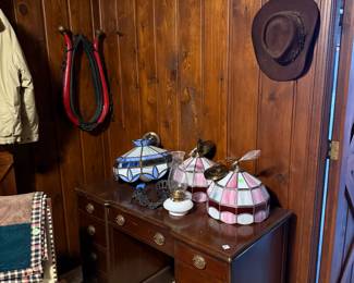 solid wood desk, Tiffany light fixtures, oil lamp and cast iron holder, antique horse yoke. 