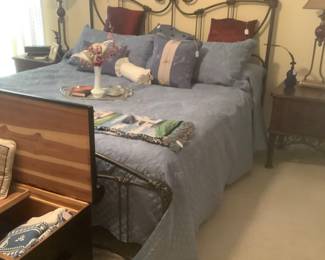 The beautiful cast iron bed, King size.  Mattress and box springs included.  The end tables will be sold with bed as a group.