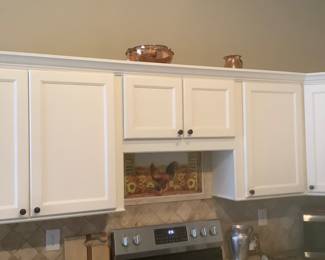 Copper pieces on top of the cabinets.