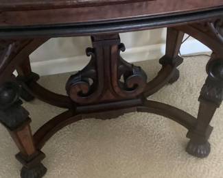 The bottom front of the antique table.