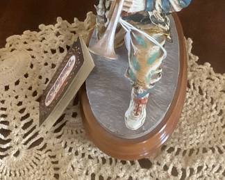 A collectible ceramic clown playing his horn.