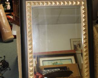 Large mirror with gold and black frame