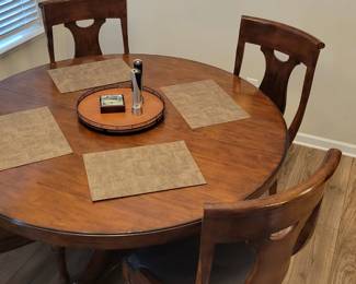 $1800 Hooker Furniture solid wood expandable dining room table with 4 chairs. Has 1 18" leaf (not pictured). 
Description from website:
Features: One 18'' leaf extends table to 78''
Will seat up to six guests with leaf in place
Traditional/Formal styling
Material: Alder Veneers
Finish: Medium Wood
Finish: A warm, chestnut-colored, physically distressed finish over figured Alder veneers create a canvas of comfort and classic appeal for the Tynecastle collection, accented by custom hardware in an aged copper finish. Distressing includes scratch antiquing, rock, cow-tailing and rasping.
Style: Traditional
Collection: Tynecastle
Width: 60" (152.4 cm)
Depth: 60" (152.4 cm)
Height: 30" (76.2 cm)
Weight: 200 lb (90 kg)
New condition.
Table alone retails for $2050