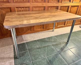 Mid Century burlwood formica dining table with chrome legs.  This has one one leaf in it as pictured