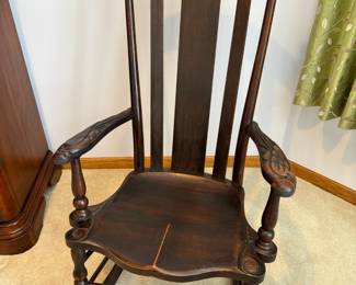 Antique mahogany rocking chair with hand carved Parrot arms, attributed to the Milwaukee Chair Co. 