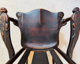 Antique mahogany rocking chair with hand carved Parrot arms, attributed to the Milwaukee Chair Co. 