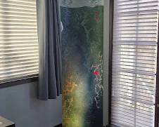 Solid Glass Sculpture by Local Artist. This has a backlight which shows the beautiful veins of varying colors throughout it. 