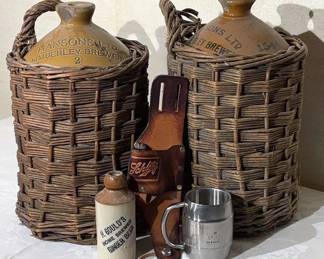 Two Stoneware Jugs In Wicker Baskets