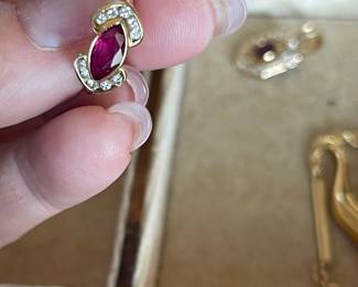 Item 36 - Ring
One diamond and ruby fashion ring with the following characteristics:
Total Diamond Weight: 0.25 ct
Item Attributes
Weight: 2.90 gms
Metal: 18K yellow gold
Manufacturing: Custom wax and cast
Condition: Good
Finish: Polished
Setting: Bezel, channel set
Trademark: None
Natural Diamond Melee Attributes
Shape and cut: Round full cut
Weight: 0.025 ct each
Number of diamonds: 10
Total Weight: 0.25 ct (estimated)
Measurements: 1.7 mm
Clarity: VS
Color: G-H
Cut: Good
Polish: Good
Setting: Channel set
Natural Ruby (Corundum) Attributes
Shape and cut: Marquise shaped faceted
Measurements: 9.00 x 4.50 x 2.72 mm (approximate)
Weight: 0.75 ct (estimated)
Clarity: Type II, Slightly included
Color: Medium dark, Moderately Strong, strongly purplish Red (stpR 6/4) Cut: Good
Polish: Good
Brilliancy: Good - 50% to 70%
Fluorescence: Moderate red (lw)
$800