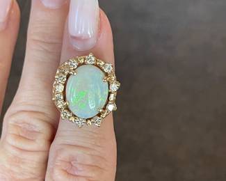 Item 29 - Ring
One opal and diamond ring with the following characteristics:
Total Diamond Weight: 0.50 ct
Item Attributes
Weight: 10.00 gms
Metal: 14K yellow gold
Manufacturing: Custom wax and cast
Condition: Good
Finish: Polished
Setting: Prong, bead set
Trademark: None
Natural Diamond Melee Attributes
Shape and cut: Round full cut
Weight: 0.05 ct each
Number of diamonds: 10
Total Weight: 0.50 ct (estimated)
Measurements: 2.2 mm
Clarity: VS
Color: G-H
Cut: Good
Polish: Good
Setting: Bead set
Natural Opal Cabochon Attributes
Shape: Oval cabochon
Measurements: 14.40 x 11.50 x 3.30 mm (approximate)
Weight: 2.70 ct (estimated)
Type: White
Clarity: Lightly fractured
Color(s): Green, Blue
Color intensity: Moderate
Fire Pattern: Rolling Flashfire
Cut: Good
Polish: Good
$1240
