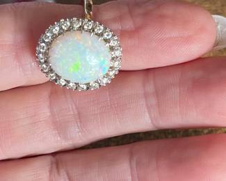 (760)-716-4342
Item 24 - Ring
One opal and diamond ring with the following characteristics:
Total Diamond Weight: 0.50 ct
Item Attributes
Weight: 6.40 gms
Metal: 14K white gold
Manufacturing: Custom wax and cast
Condition: Good
Finish: Polished
Setting: Prong, bead set
Trademark: None
Natural Diamond Melee Attributes
Shape and cut: Round full cut
Weight: 0.025 ct each
Number of diamonds: 20
Total Weight: 0.50 ct (estimated)
Measurements: 2 mm
Clarity: VS
Color: G-H
Cut: Good
Polish: Good
Setting: Bead set
Natural Opal Cabochon Attributes
Shape: Oval cabochon
Measurements: 14.30 x 11.90 x 4.20 mm (approximate)
Weight: 4.00 ct (estimated)
Type: White
Clarity: Lightly fractured
Color(s): Green, Blue, Yellow, Orange
Color intensity: High
Fire Pattern: Rolling Flashfire
Cut: Good
Polish: Good
$1640