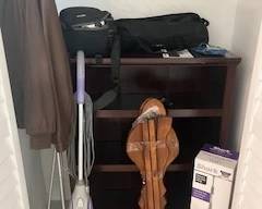 small book shelf and vacuumes