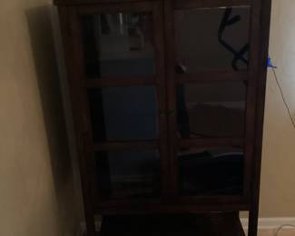 Dark wood display cabinet with glass door