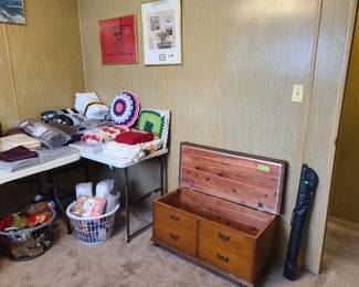 Vintage chest by Lane, blankets, curtains, and a few stuffed animals.