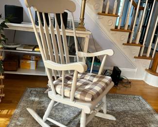 B46 - $40. White Wooden Rocking Chair. Sturdy. Measures 24" wide x 23" deep 29" tall. 