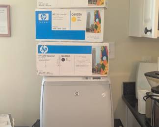 B49 - $200 .  HP Color Laser Jet 2600n Printer and several unopened ink cartridges. Black, Yellow, blue and magenta. 