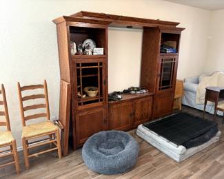 Entertainment Center with built-in Lighting, 3 dog beds, XL dog kennel, and 2 wooden chairs with woven seats