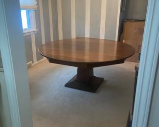 Round wood table ; 66 inch diameter; seats 8-10 comfortably, custom table cloths included