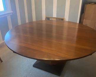 Round wood table ; 66 inch diameter; seats 8-10 comfortably, custom table cloths included