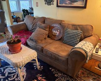 Suede sofa and wicker table