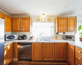 Microwave, coffee pot, toaster oven, dishes , glasses, utensils